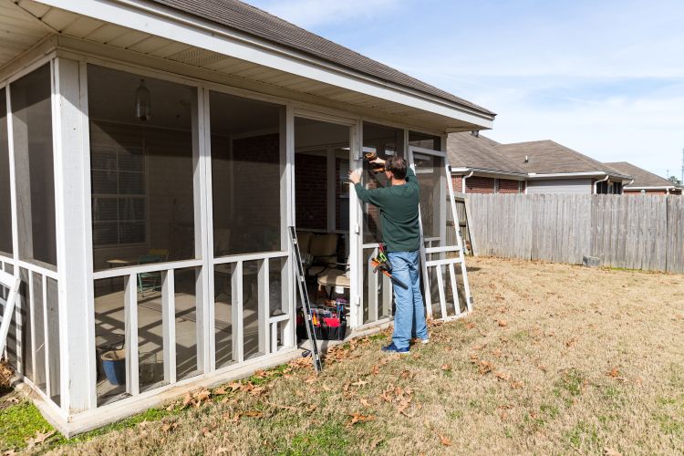 Screen Room Builder Working on a Screened Patio